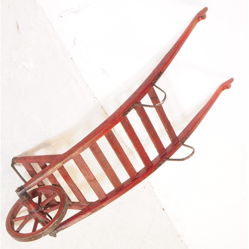 994 - A late 19th century Victorian red lacquered sack barrow. The barrow having a single wheel to front, ... 