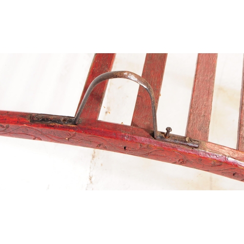 994 - A late 19th century Victorian red lacquered sack barrow. The barrow having a single wheel to front, ... 