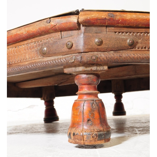 998 - A 19th century Indian low hardwood Bajot meditation table. The table raised on turned rounded legs, ... 