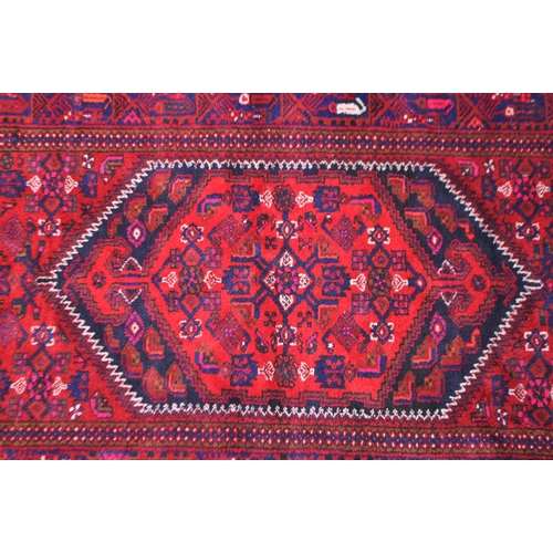 1038 - A mid 20th century Persian Malayer hand knotted carpet floor rug. The rug having a red ground with d... 