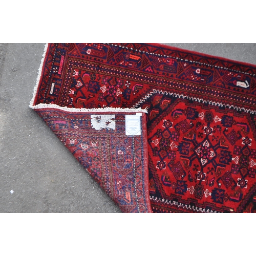 1038 - A mid 20th century Persian Malayer hand knotted carpet floor rug. The rug having a red ground with d... 