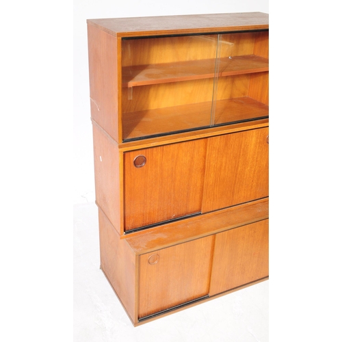 666 - Avalon - A retro mid 20th century teak Ladderax shelving wall system. The three cabinets of rectangu... 