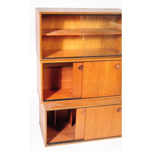 666 - Avalon - A retro mid 20th century teak Ladderax shelving wall system. The three cabinets of rectangu... 