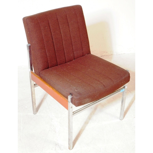 672 - Antocks Lairn - A mid 20th century retro armchair. Having a brown fabric padded backrest and seat on... 