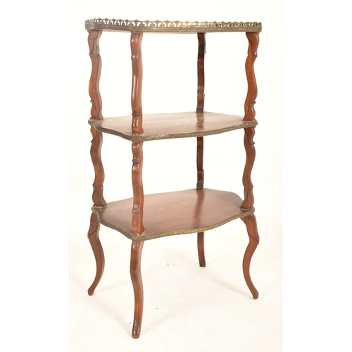 903 - A French Continental 19th century mahogany inlaid three tier serpentine shaped whatnot etagere. The ... 