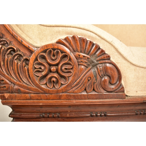 906 - A 19th century Anglo Colonial scroll ended chaise lounge / sofa settee. The chaise having a carved m... 