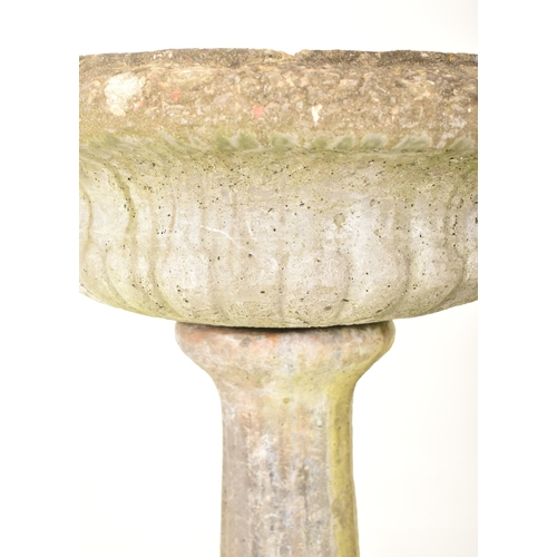 949 - A 20th century composite stone garden feature bird bath / urn. The birdbath separating into two piec... 