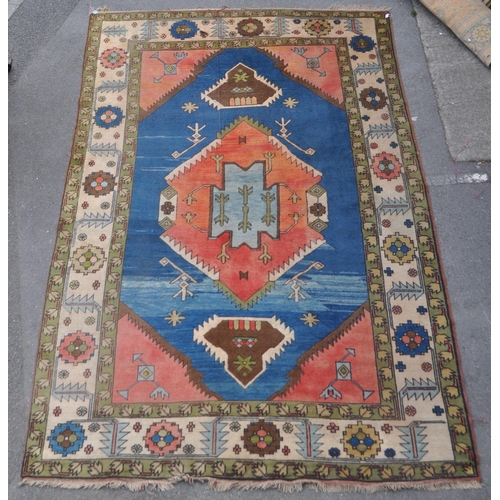 966 - A mid 20th century Anatolian Turkish Kars style carpet floor rug. The carpet featuring a large centr... 