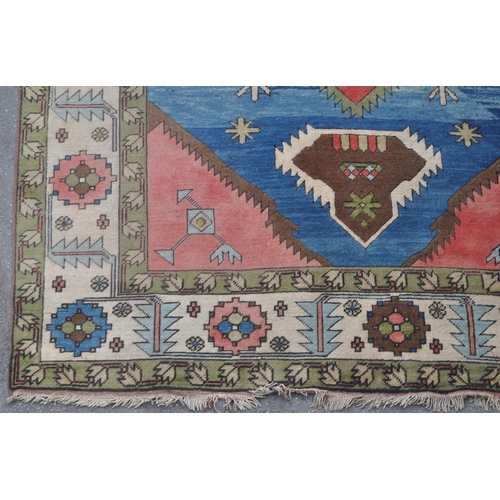 966 - A mid 20th century Anatolian Turkish Kars style carpet floor rug. The carpet featuring a large centr... 