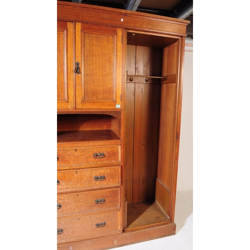 967 - A large Edwardian oak wood compactum wardrobe. Of rectangular form with bank of drawers to centre wi... 