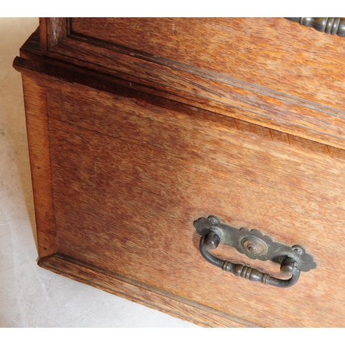 967 - A large Edwardian oak wood compactum wardrobe. Of rectangular form with bank of drawers to centre wi... 