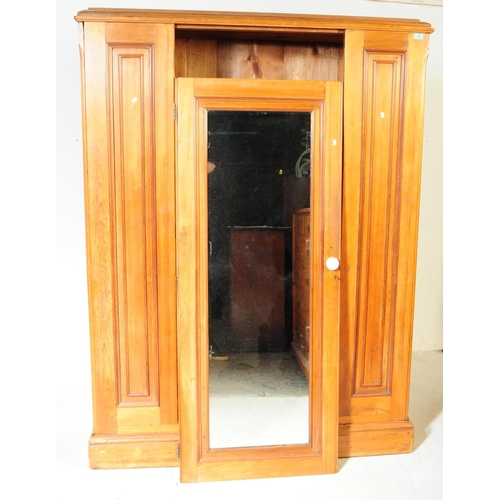 968 - A 19th century Victorian pine wardrobe. The wardrobe having pediment to top over central mirrored do... 