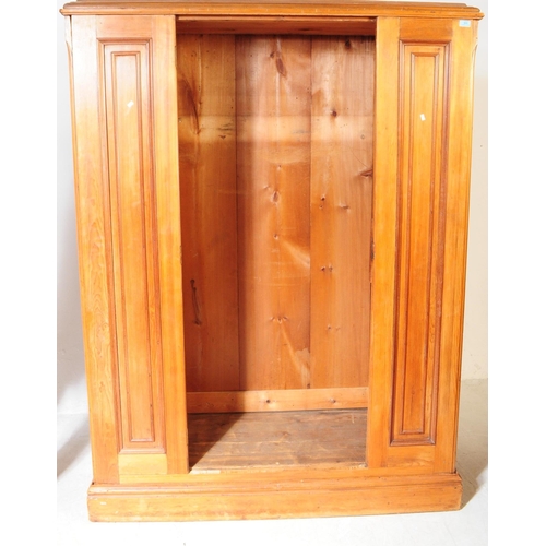 968 - A 19th century Victorian pine wardrobe. The wardrobe having pediment to top over central mirrored do... 