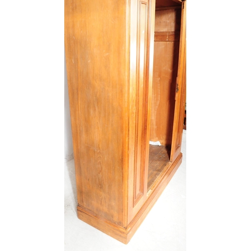 968 - A 19th century Victorian pine wardrobe. The wardrobe having pediment to top over central mirrored do... 