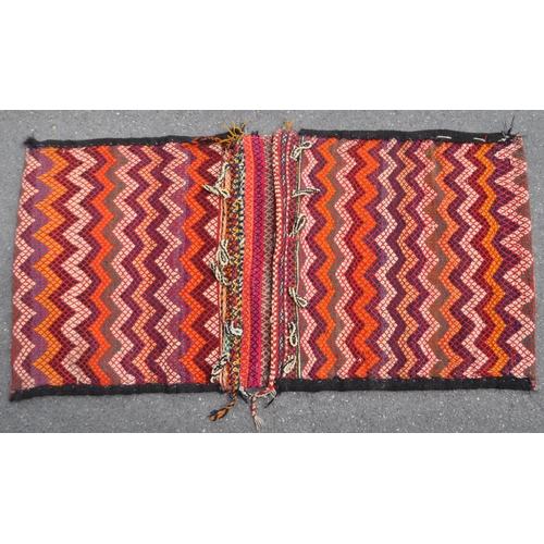 971 - A 20th century North West Persian Sumak Kilim saddle bag / rug. The rug having polychrome repeated g... 