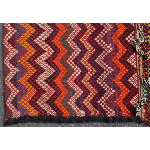 971 - A 20th century North West Persian Sumak Kilim saddle bag / rug. The rug having polychrome repeated g... 