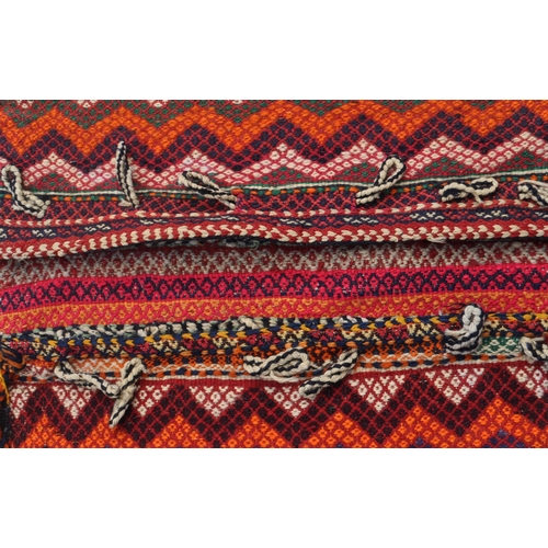 971 - A 20th century North West Persian Sumak Kilim saddle bag / rug. The rug having polychrome repeated g... 