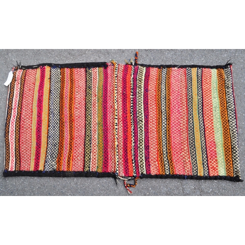 971 - A 20th century North West Persian Sumak Kilim saddle bag / rug. The rug having polychrome repeated g... 