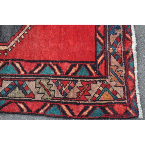 977 - A 20th century North West Persian Hamadan carpet runner floor rug. The rug having a red ground, with... 