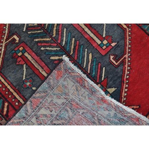 977 - A 20th century North West Persian Hamadan carpet runner floor rug. The rug having a red ground, with... 