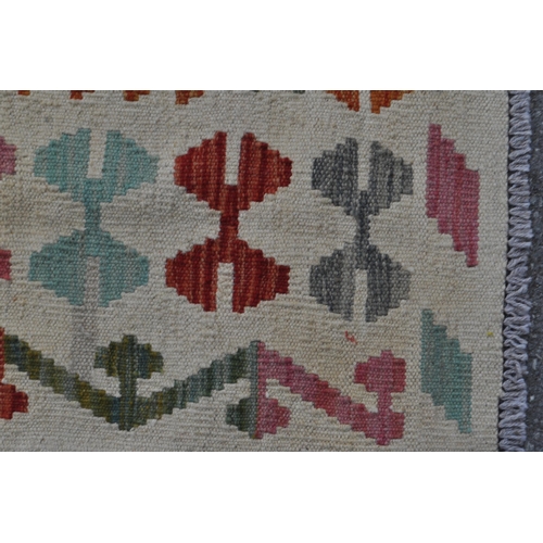 978 - A 20th century Anatolian Turkish Kilim carpet floor rug. The rug having cream ground with polychrome... 