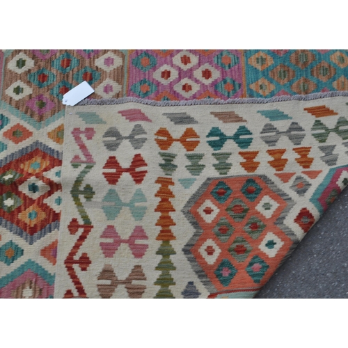 978 - A 20th century Anatolian Turkish Kilim carpet floor rug. The rug having cream ground with polychrome... 