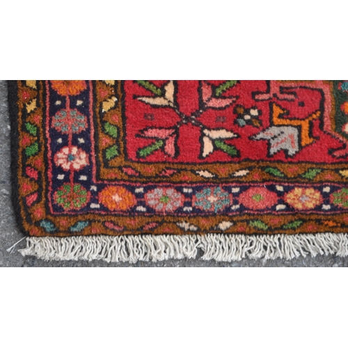 982 - A 20th century North West Persian Heriz runner carpet floor rug. Having a red central field populate... 