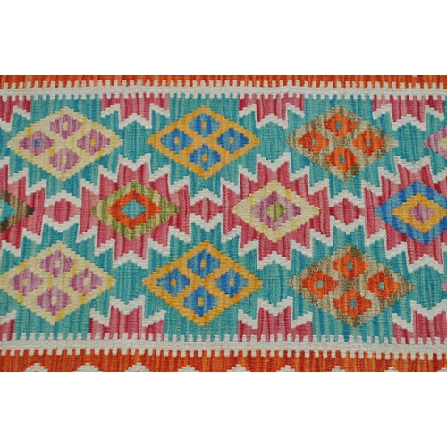 983 - A 20th century Anatolian Turkish kilim runner carpet floor rug. The rug featuring a green central fi... 