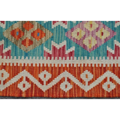 983 - A 20th century Anatolian Turkish kilim runner carpet floor rug. The rug featuring a green central fi... 