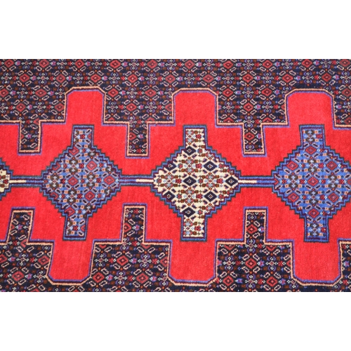 989 - A 20th century North West Persian Senneh runner carpet floor rug. The runner featuring a stepped geo... 