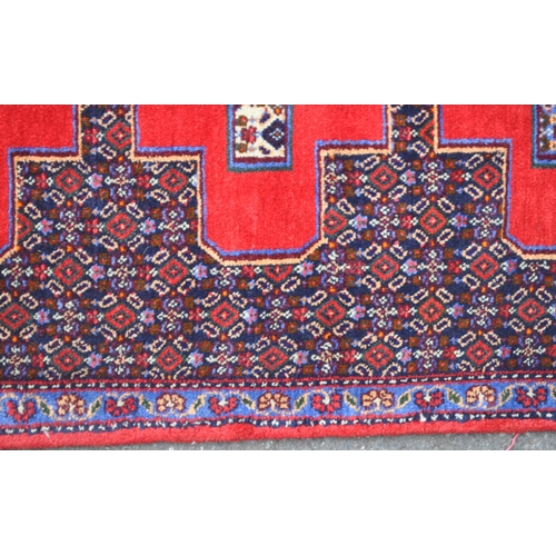 989 - A 20th century North West Persian Senneh runner carpet floor rug. The runner featuring a stepped geo... 