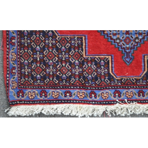 989 - A 20th century North West Persian Senneh runner carpet floor rug. The runner featuring a stepped geo... 