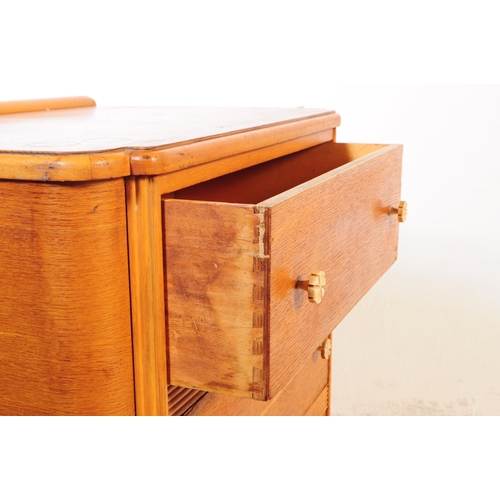 725 - British Modern Design - A mid 20th century circa 1950s oak chest of drawers. The chest of drawers ha... 