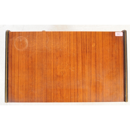 730 - British Modern Design - A mid 20th century teak veneer record cabinet. The cabinet raised on tapered... 