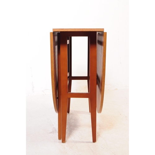 732 - British Modern Design - A mid 20th century teak wood drop leaf dining table. The table of space save... 