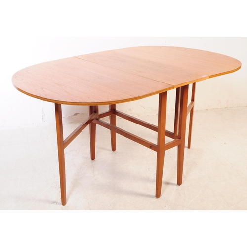 732 - British Modern Design - A mid 20th century teak wood drop leaf dining table. The table of space save... 