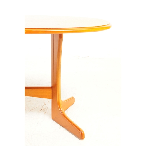 734 - British Modern Design - A mid 20th century teak wood coffee table. The table having an oval top, wit... 