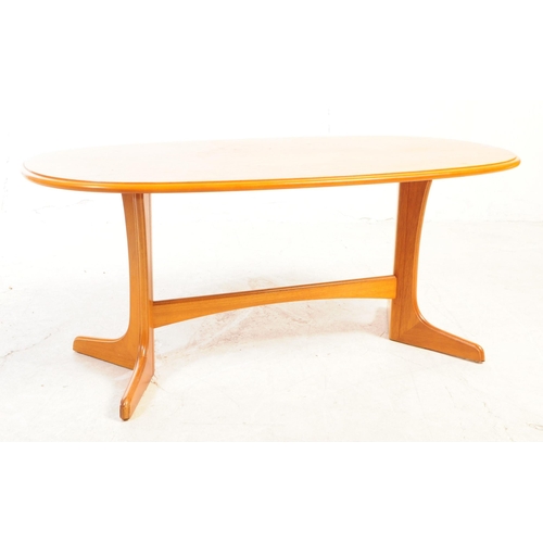 734 - British Modern Design - A mid 20th century teak wood coffee table. The table having an oval top, wit... 