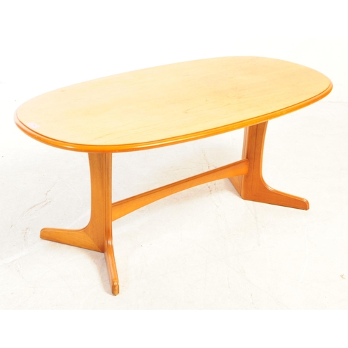 734 - British Modern Design - A mid 20th century teak wood coffee table. The table having an oval top, wit... 