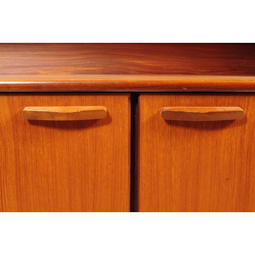 738 - British Modern Design - A mid 20th century teak wood highboard sideboard. The sideboard raised on sq... 