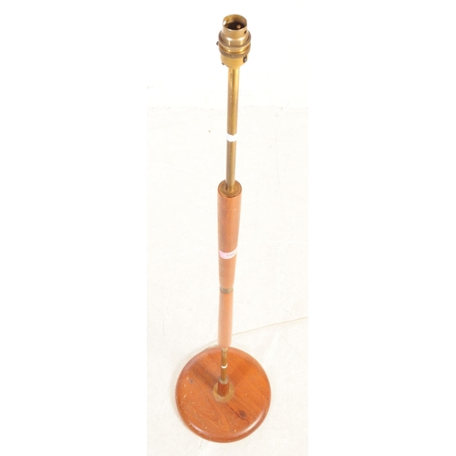 742 - A mid Century retro brass and teak floor standing standard lamp. Having circular wood base and centr... 