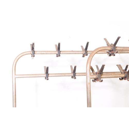 744 - Two 20th Century retro industrial metal framed clothes racks / rails having hooks along the top two ... 