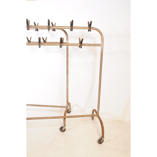 744 - Two 20th Century retro industrial metal framed clothes racks / rails having hooks along the top two ... 