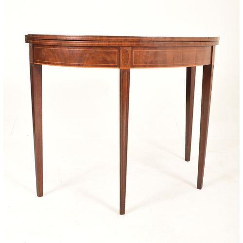 911 - An 18th century George III inlaid mahogany games / card table. The table raised on tapering legs hav... 