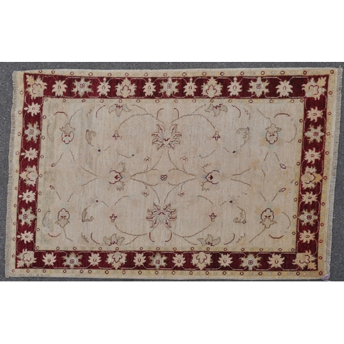 888 - A mid 20th century Persian Ziegler manner carpet rug. The rug having a cream ground with floral scro... 