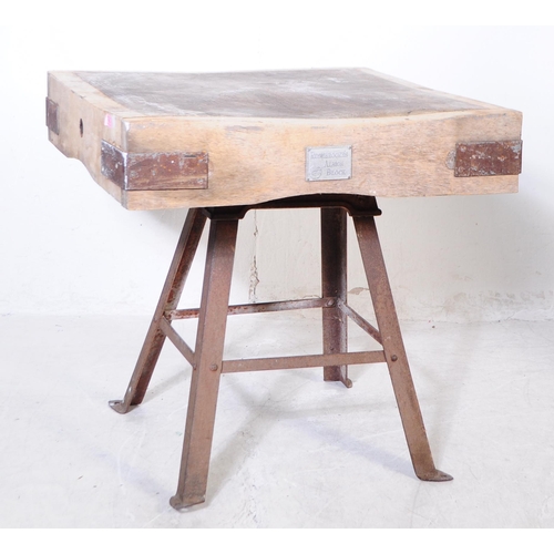 963 - A mid 20th century large butchers block. The block raised on a metal trestle style base, with metal ... 