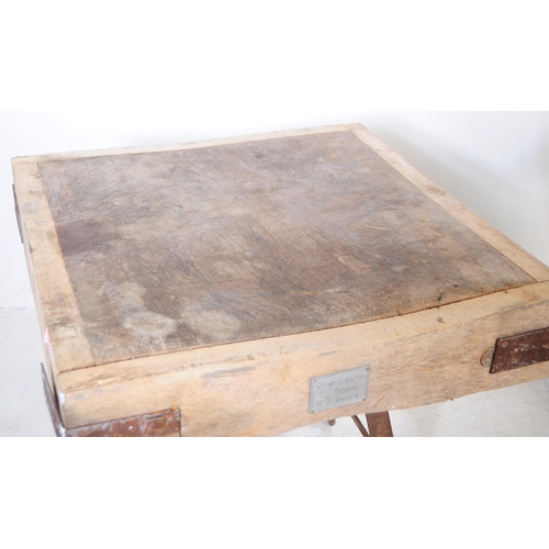 963 - A mid 20th century large butchers block. The block raised on a metal trestle style base, with metal ... 