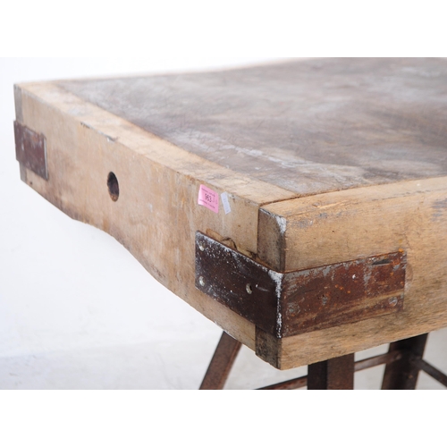 963 - A mid 20th century large butchers block. The block raised on a metal trestle style base, with metal ... 