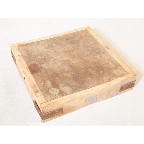 963 - A mid 20th century large butchers block. The block raised on a metal trestle style base, with metal ... 