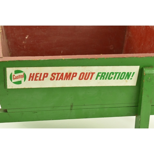 23 - Castrol - A vintage 20th century green painted advertising wooden wheelbarrow. The barrow with label... 